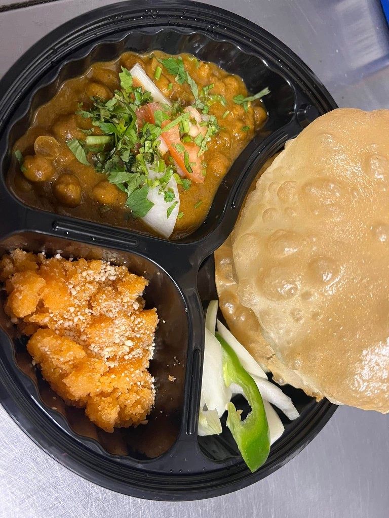 Chole bhature with puffy fried bread, spiced chickpeas, and sweet halwa