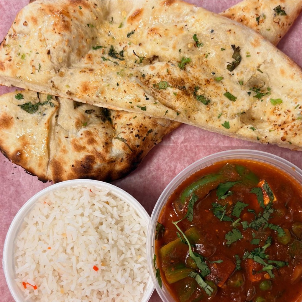 Garlic naan served with vegetable curry and basmati rice