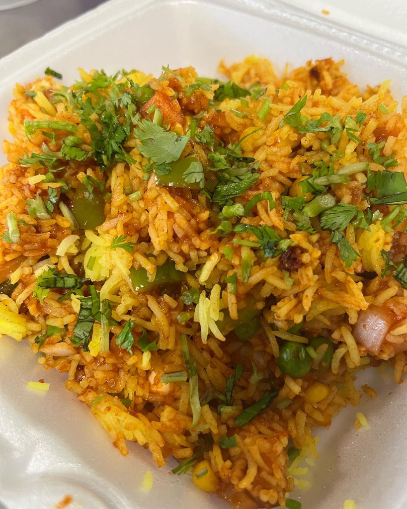 Aromatic vegetable biryani with saffron-tinted rice and fresh cilantro